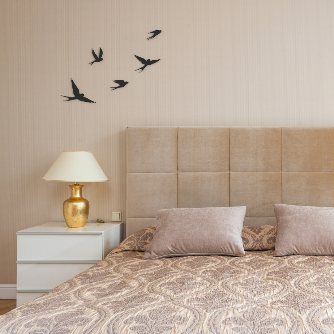 five black birds metal wall art on wall in bedroom