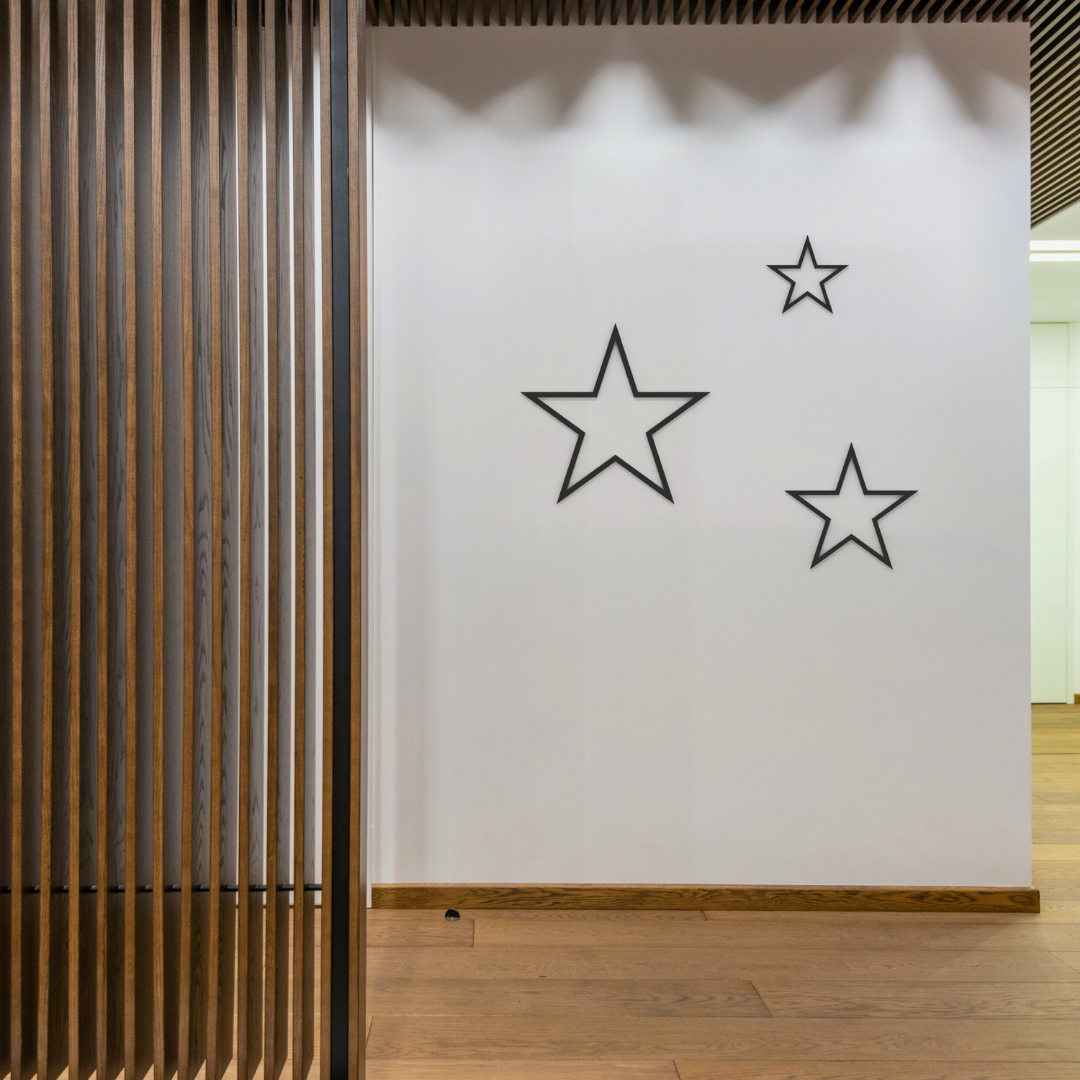 black stars trio metal wall art on wall in hallway