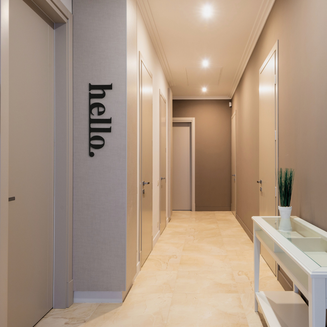 black hello metal sign on wall in hallway