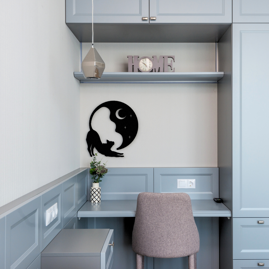black cat and moon metal wall art hanging on wall in office room