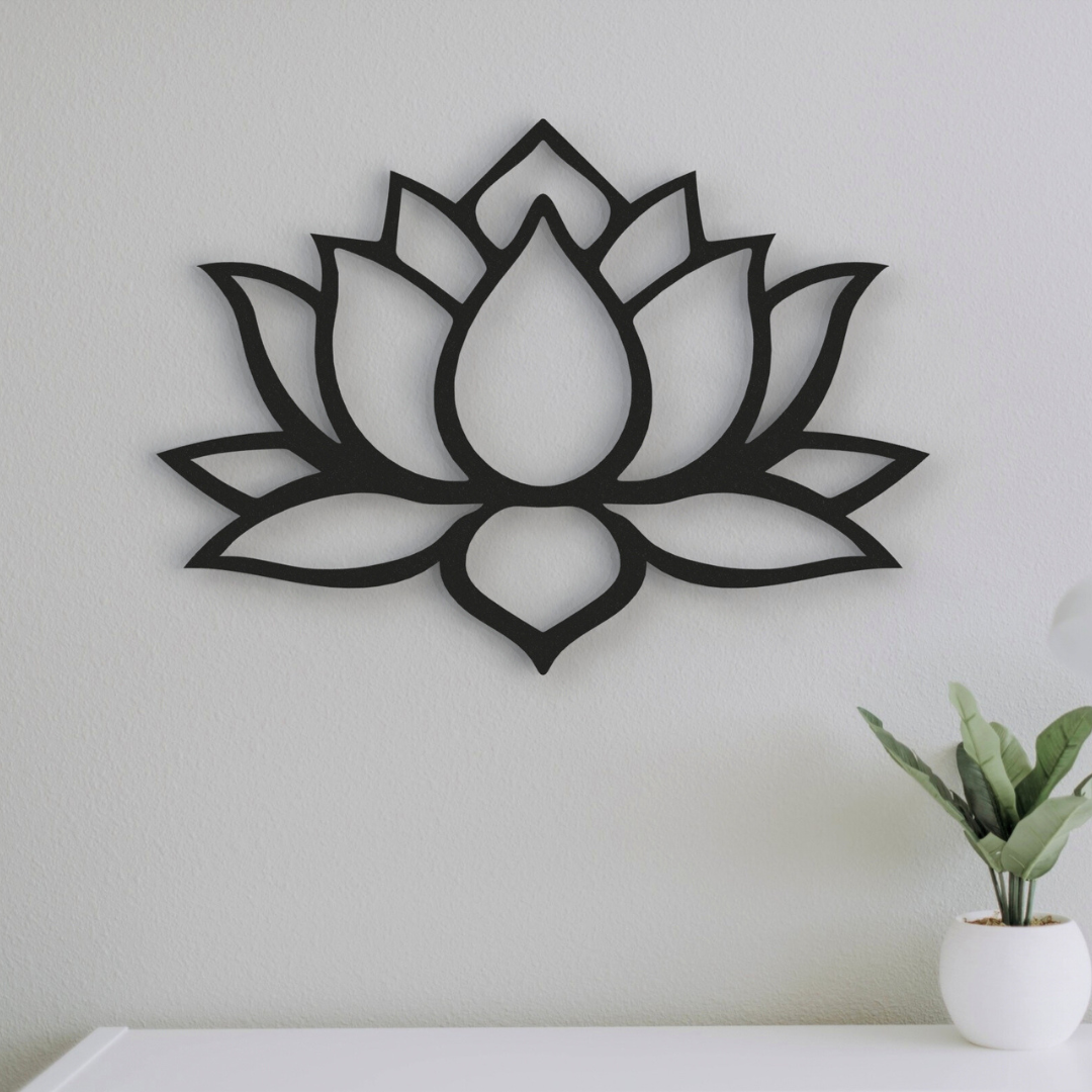 black boho lotus flower metal wall art on wall next to plant