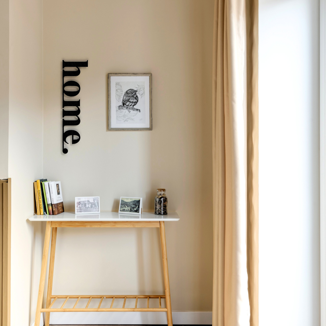 black home metal sign on wall in hallway