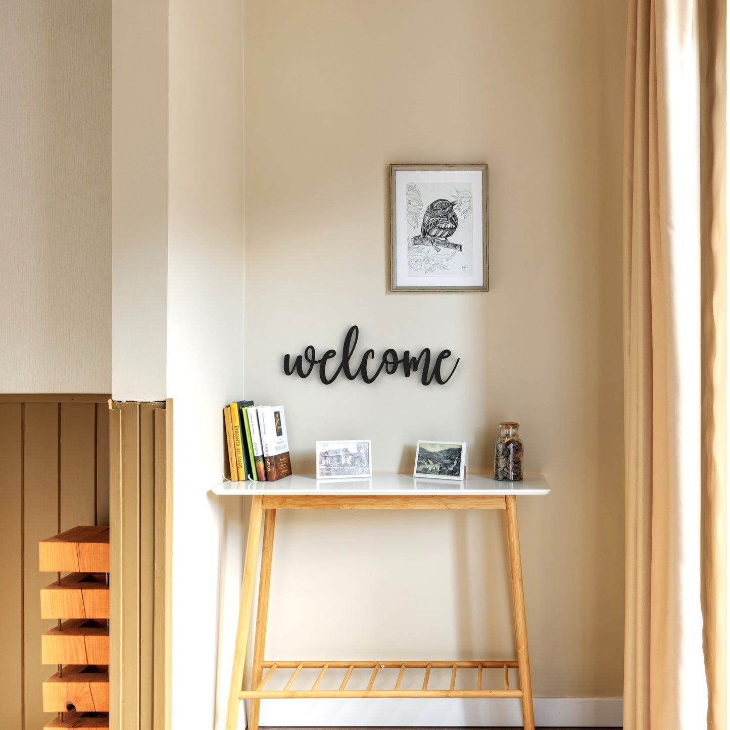black welcome metal sign hangs on wall in hallway