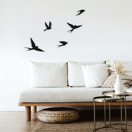 five black birds metal wall art on wall in living room