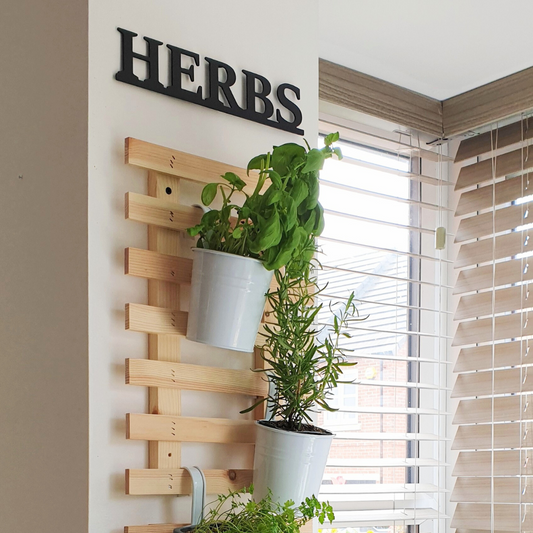 black herbs metal sign on wall in kitchen