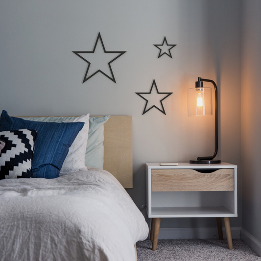 black stars trio metal wall art on wall in bedroom