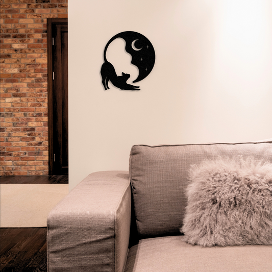 black cat and moon metal wall art hanging on wall in living room