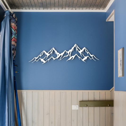 white mountains metal wall art on blue wall in hallway