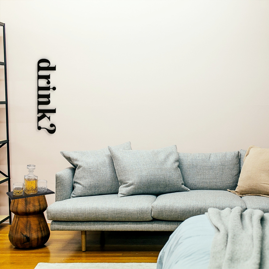 black drink metal sign on wall above drinks corner in living room