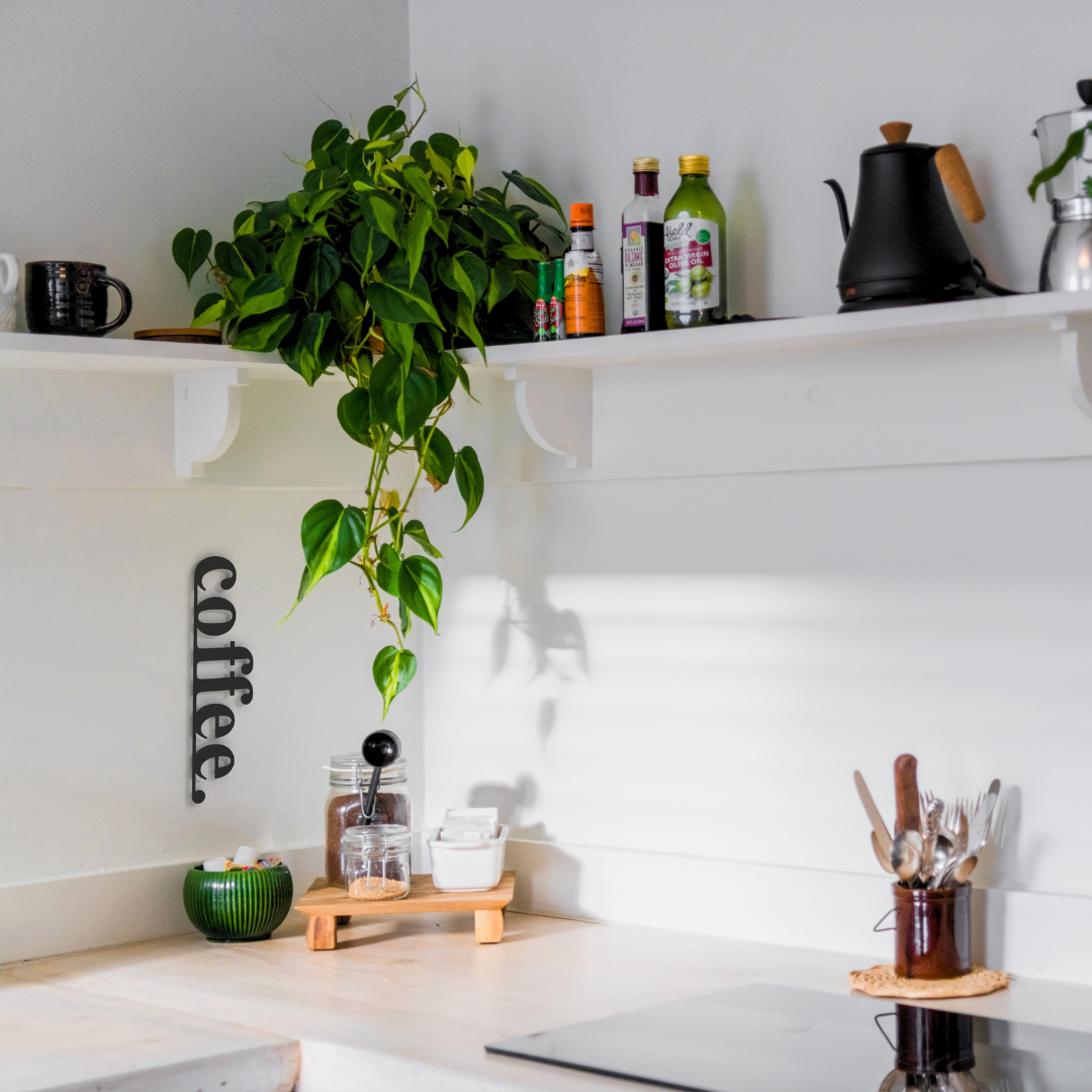 black coffee metal sign on wall in kitchen