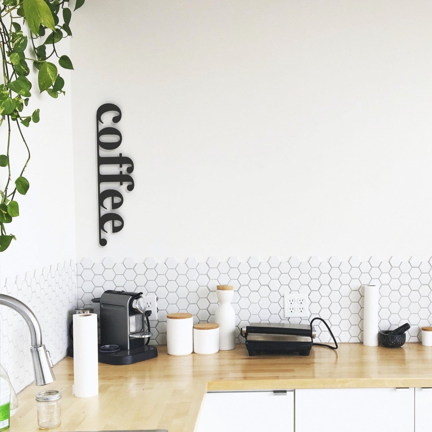 black coffee metal sign on wall in kitchen