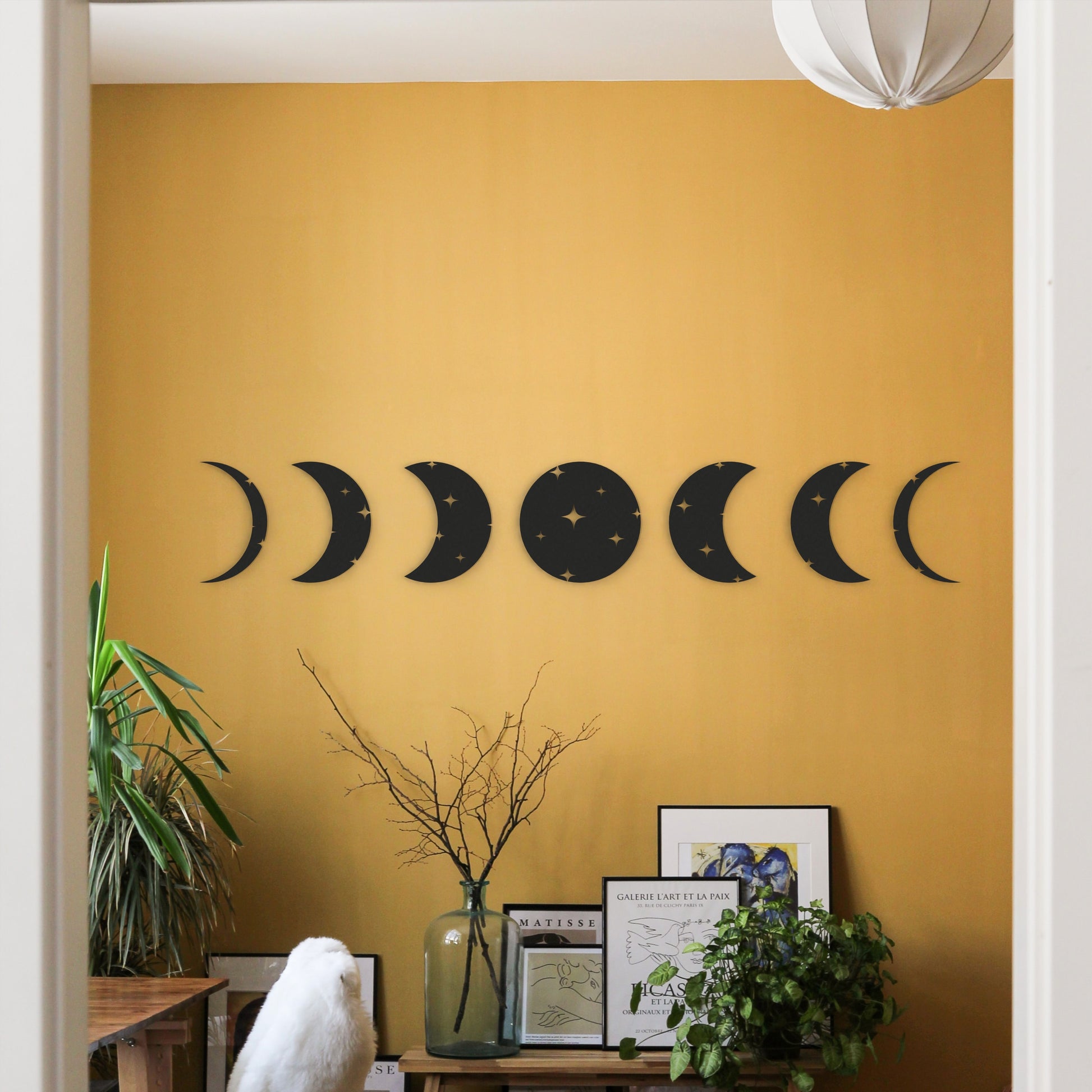 seven-moonphases-black-metal-wall-art-on-wall-in-office-room